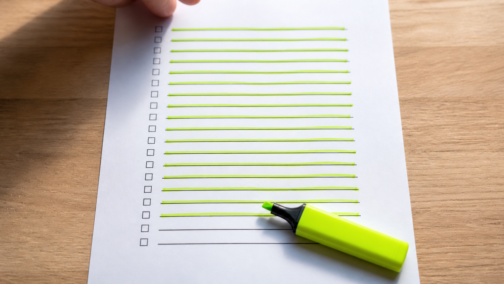A printed lead list on a desk with several rows crossed out by hand.